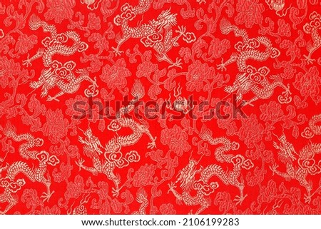 Red fabric with a dragon pattern. The concept of the Chinese New Year. copy space. Red background.