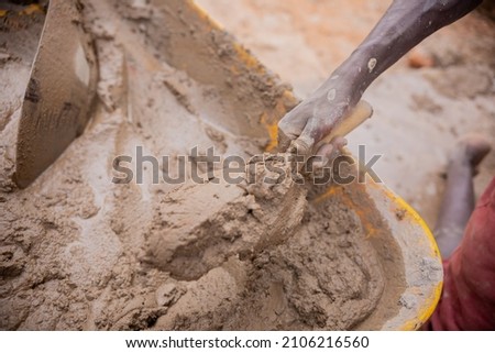 Lusaka, Kaunda Square, Zambia, 20,09,2021.., African Builder plastering a house . Normal African works, African man Working with his hands  Royalty-Free Stock Photo #2106216560