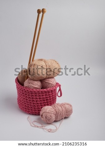 Wool yarn in different colors with wooden double point needles. The needles are being used for knitting socks, mittens or other projects joined in the round.         