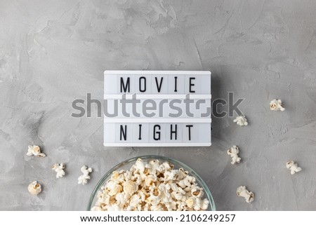 Text MOVIE NIGHT and popcorn in bowl. Movie theater and cinema snacks