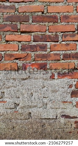 Abstract Defocused background photo of a red brick wall with a little spilled cement