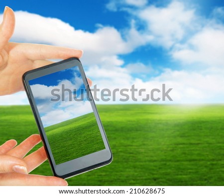 phone in hand taking landscape picture