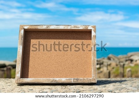 Wooden frame with blurred background of ocean. Copy space