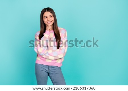 Photo of intelligent cute school girl dressed prink pullover arm chin looking empty space isolated teal color background