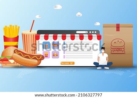 Concept of fast food delivery, young man wear a face mask and sit in front of a big screen of web browser to order fast food (sparkling water, hot dog with mustard, hamburger and french fries).