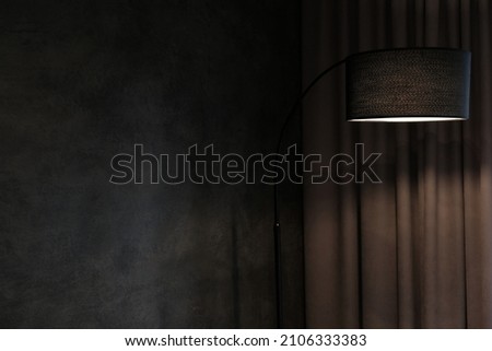 Floor lamp in the dark interior of the apartment