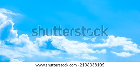 A vast blue sky with freedom shape of fluffy clouds floating over the air. Soft and pure cloudy in sunny day, calm and tranquil nature scene. Abstract background of panoramic natural cloudscape. Royalty-Free Stock Photo #2106338105