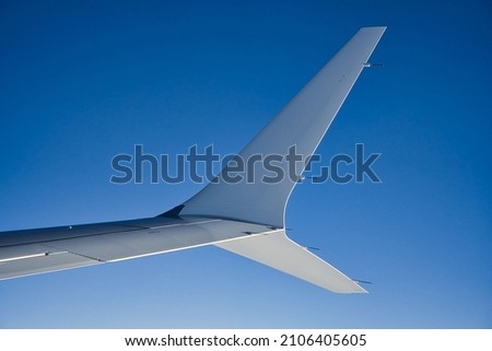 split scimitar airline winglet against sky Royalty-Free Stock Photo #2106405605