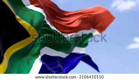 Detailed close up of the national flag of South Africa waving in the wind on a clear day. Democracy and politics. African country. Selective focus. Royalty-Free Stock Photo #2106410150