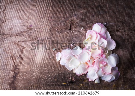 Heart from rose petals on  wooden background. Place for text.