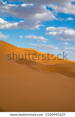 Sand dunes in Morocco. Erg Chebbi Sahara desert. Yellow red sand and blue sky Royalty-Free Stock Photo #2106441629