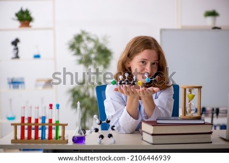 Young female chemist student studying molecular model Royalty-Free Stock Photo #2106446939