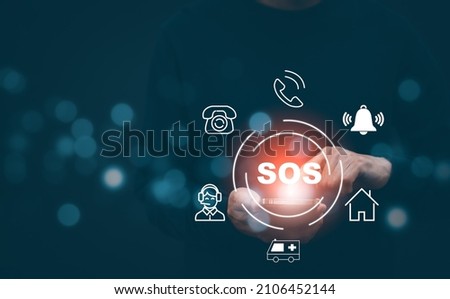 Man using Smart Phone with Emergency app in home, call phone, Chat message icon, Emergency application from smartphone for elderly, technology concept.Old hand touch mobile phone and call for help. Royalty-Free Stock Photo #2106452144