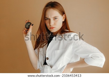 Beautiful woman in white shirt posing with a compass in hand