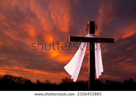 This dramatic sunrise lighting and Easter Cross makes a great Easter photo illustration of Jesus dying on the cross and rising again. Royalty-Free Stock Photo #2106455885