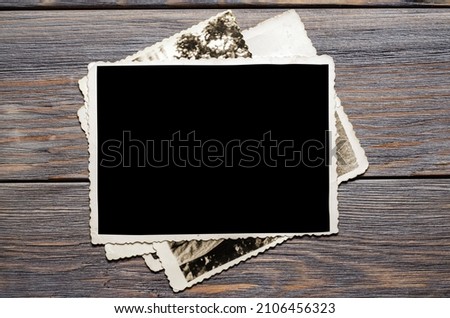 Old photos on a wooden brown background. Copy space