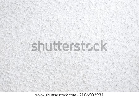 White wall with uneven texture.
