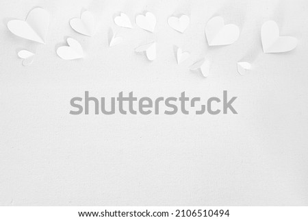 Valentines Day or wedding, invitation, small cut out white hearts on white canvas background, copy space