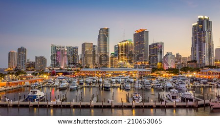 Miami city skyline panorama at twilight with urban skyscrapers, marina and bridge