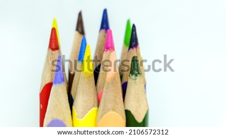 Many multicolor pencils forming a rainbow on white background. Isolated close up shot for back to school. 