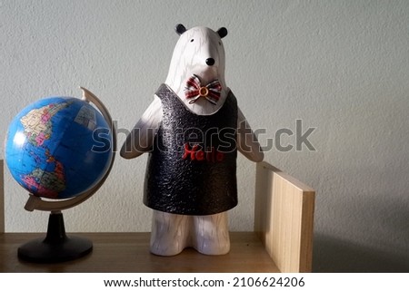 Globe and a bear on wood book shelf 