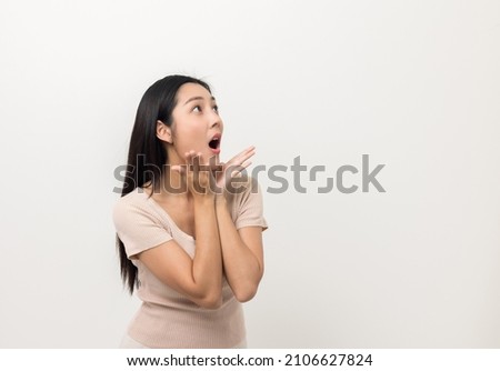 Excited asian woman shout out loud wow with hands on isolated white background. Happy shocked face female wow promotion advertising concept. Joyful teenage girl standing in white room.