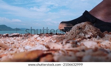 This picture is a work of art. It was intended to be photographed as a giant foot stepping on a sandy beach in a human city. Taken at Koh Nok Island, Phang Nga Province, Thailand.