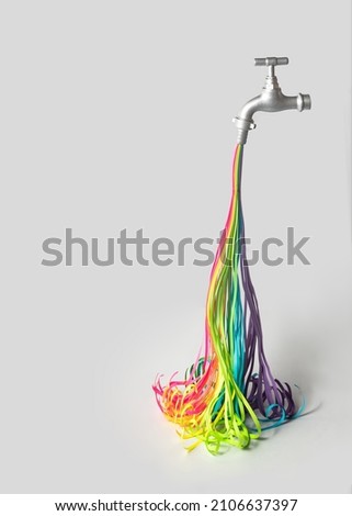 Different colors as water stream fall from faucet on white background. Minimalistic funny concept. Creative abundance composition.