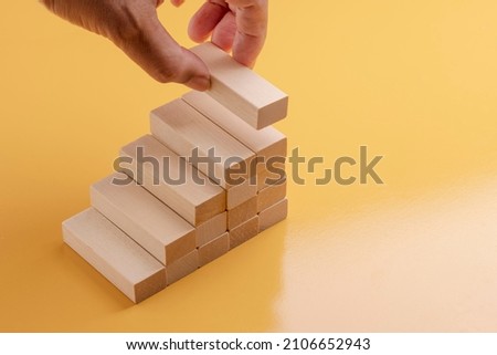 Picking up wood to build a new step ladder. Royalty-Free Stock Photo #2106652943