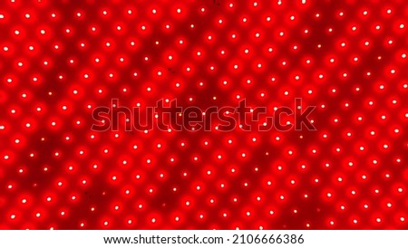 Background of red LED lamps, LED strip, red flashing lights, LED pads, red color background with light dots, space for text 
