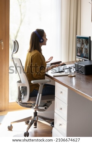 Millennial student, intern girl in headphones watching learning webinar, attending virtual online training, studying at home. Business woman, employee talking to team on video call, conference chat Royalty-Free Stock Photo #2106674627