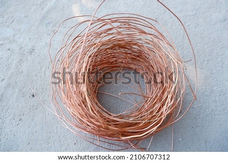 Copper wire on a plaster background.