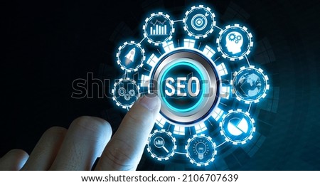 Businessman's fingers pressing a button SEO. Search engine optimization, Digital marketing and internet technology concept on blurred background Royalty-Free Stock Photo #2106707639