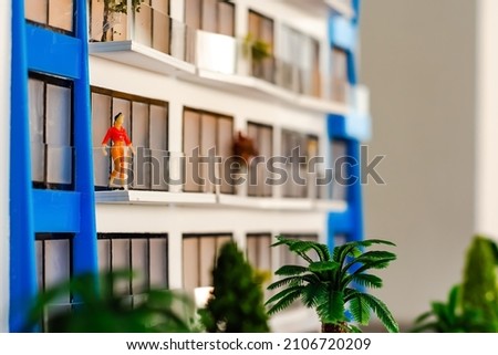 Toy house and cars, miniature residential area.