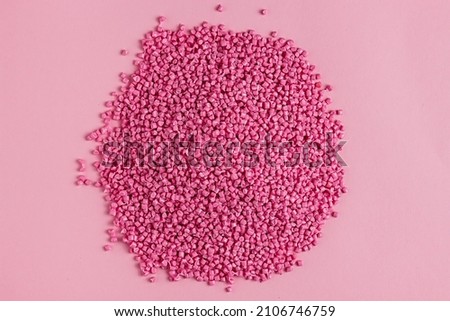 Pink granules of polypropylene or polyamide. background. Plastics and polymers industry. Monochrome Royalty-Free Stock Photo #2106746759