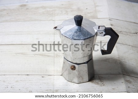 Moka Pot on a wooden floor Coffee pot on a wooden floor