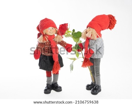 Dolls, a boy and a girl with flowers, make congratulations
On a white background .Concept .Postcard for Valentine's Day, Friend's Day, February 14, mother's day