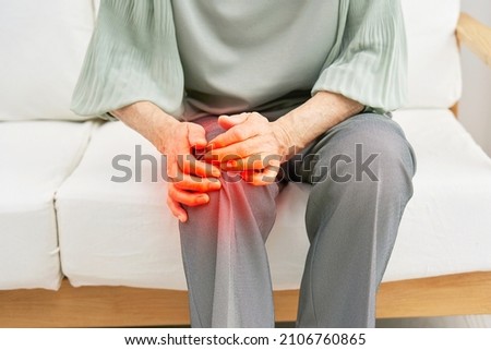 Asian senior woman having the joint pain, no face Royalty-Free Stock Photo #2106760865