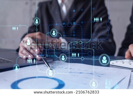 Two HR specialists man and woman analyzing the market of alumni to boost the intern program at international consulting company. Hiring new talented officers. Social media hologram icons. Royalty-Free Stock Photo #2106762833