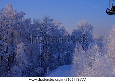 Snow-covered trees in hoarfrost at a ski resort, ski lift