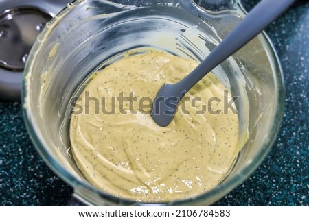 View of poppy seed Bundt cake batter in a glass mixing bowl.