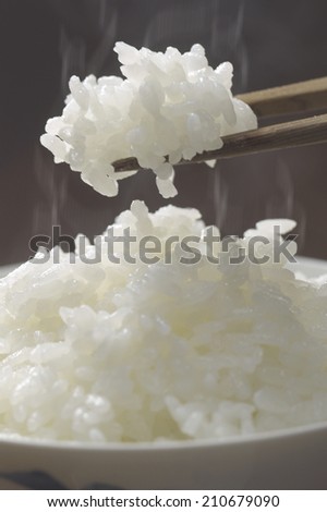 Holding Steaming Rice With Chopsticks