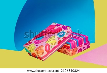 Several multicolored gift boxes on a colored background.Yellow,pink,blue,fashionable.Modern art