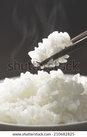 Holding Steaming Rice With Chopsticks