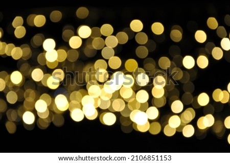 Golden bokeh in black. Gold glittering sparkle stardust space background