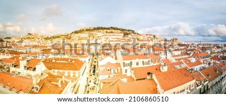 Saint George's Castle and Lisbon old town from Santa Justa mirador at sunset, Portugal, wide panorama, web banner format