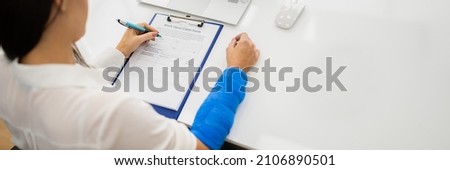 Worker Filling Social Security Benefits And Disability Insurance Compensation Claim Royalty-Free Stock Photo #2106890501