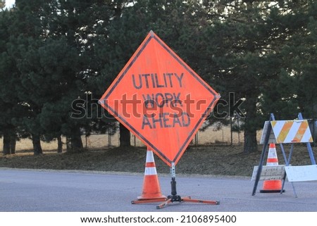 A Utility Work ahead sign in the highway north of Hutchinson Kansas. That's to stop traffic for replacing broke off telephone poles when there were Hurricane winds in Hutchinson Kansas USA. 