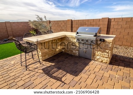 Rear Patio BBQ Station And Counter With Wicker Stools Royalty-Free Stock Photo #2106906428