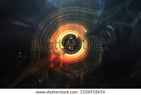 Astronaut looks at black hole and event horizon. 5K realistic science fiction art. Elements of image provided by Nasa Royalty-Free Stock Photo #2106918656